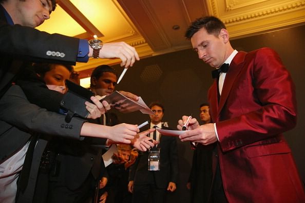 FIFA Ballon d'Or nominee Lionel Messi of Argentina and Barcelona signs autographs during the FIFA Ballon d'Or Gala 2013